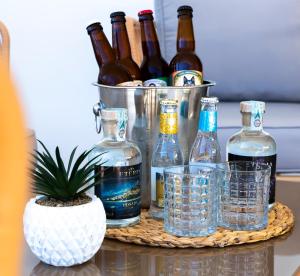 a basket of bottles and glasses on a table at Eteria Luxury Rooms Spa & Wellness in Posada