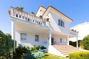 a white house with stairs and a balcony at Eteria Luxury Rooms Spa & Wellness in Posada