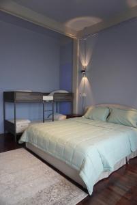a bedroom with a large bed with blue walls at Room with a Temple View in Bangkok