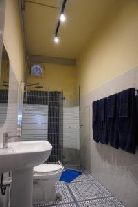 a bathroom with a toilet and a sink and a shower at Room with a Temple View in Bangkok