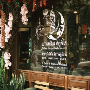 a sign in the window of a restaurant with a menu at Room with a Temple View in Bangkok