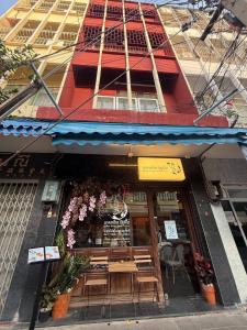 a restaurant with wooden tables in front of a building at Room with a Temple View in Bangkok +17 photos