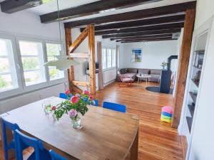 a dining room with a table and blue chairs at Reethaus Beusloe I in Beusloe