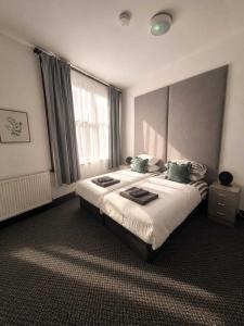 a hotel room with two beds and a window at GuestReady - The Hangman in Liverpool