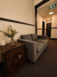 a living room with a couch and a table at GuestReady - The Hangman in Liverpool
