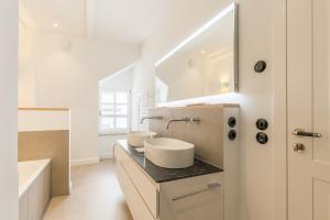 a bathroom with two sinks on a counter with a mirror at Strandvilla Lilli in Timmendorfer Strand