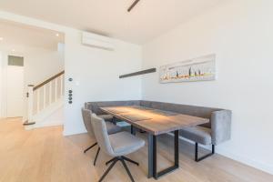 a dining room with a wooden table and chairs at Strandvilla Lilli in Timmendorfer Strand +20 photos