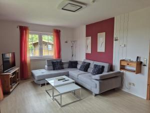 a living room with a couch and a table at Feldblick in Krummhörn
