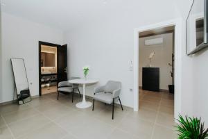 a white room with a table and chairs in it at Breathtaking view guesthouse2 in Psalidi