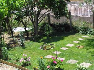 a garden with some flowers in the grass at Villa Fotini III in Amalias