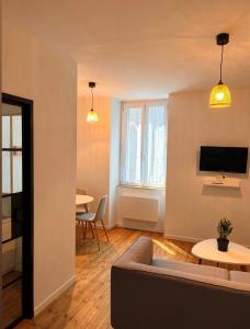 a living room with a couch and a table at Petite rivière in Nantes