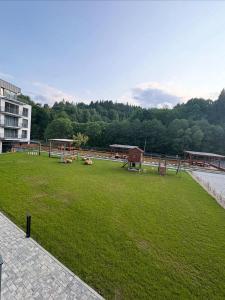 a green field with animals laying on the grass at Apartment Nordic in Veselé +14 photos