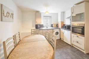 a kitchen with a table and chairs in it at Skinningrove Beach Apartment 5 in Skinningrove