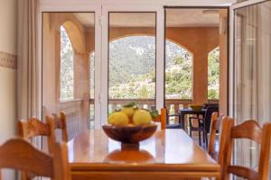 a dining room table with a bowl of fruit on it at Can Cega in Bunyola
