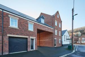 a large brick building with a large garage at Skinningrove Beach Apartment 5 in Skinningrove