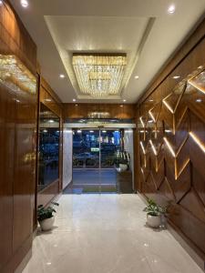 an office lobby with a hallway with a chandelier at Hotel Krishna in Katra