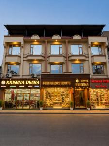 a store front of a building with many windows at Hotel Krishna in Katra