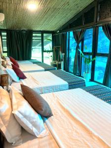 two beds in a room with large windows at Greenfield Ba Vì - Nắng Villa in Yên Bài +35 photos