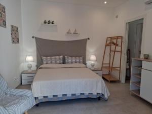 a bedroom with a bed and two lamps and a ladder at Ca' Dora in Otranto