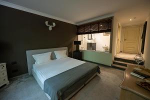 a bedroom with a white bed and a window at Villa VICTORIA Loven Park Boutique Rooms Sofia in Sofia