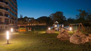 a playground at night with rocks and lights at Skyline Apartments - Sea View, Pools, SPA&Free Parking in Varna City
