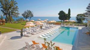 a swimming pool with lounge chairs and umbrellas at Skyline Apartments - Sea View, Pools, SPA&Free Parking in Varna City +23 photos