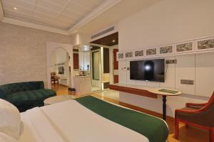 a hotel room with a bed and a television at Hotel Pacific Primee in Zirakpur