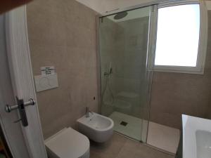 a bathroom with a shower and a toilet and a sink at Ca' Dora in Otranto
