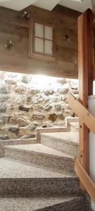 a set of stairs in a building with a window at Dolomiti Alpine Homes - Appartamento Brenta in Giustino