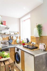 a kitchen with a sink and a washing machine at My cocoon in Vaison in Vaison-la-Romaine