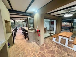 a kitchen and dining room with a table and chairs at Athule Inn - Cradle in Hekpoort