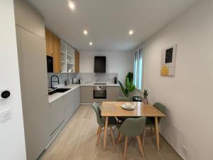 a kitchen and dining room with a table and chairs at Frontière de Monaco - Spacieux et confortable - GM in Beausoleil