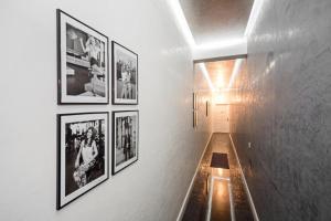 a hallway with framed pictures on a wall at Arabel Design Apartments in Berlin