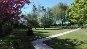 a garden with trees and a walkway at Birkenhof in Achtrup