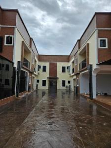 an empty courtyard of a building in the rain at Oak Haven Lodging & Suites in Sagamu +13 photos