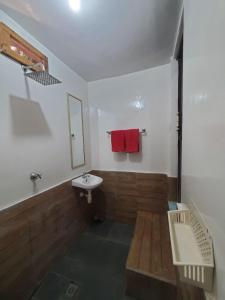 a bathroom with a sink and a red towel at Pondok Kebun Jati in Pawenang