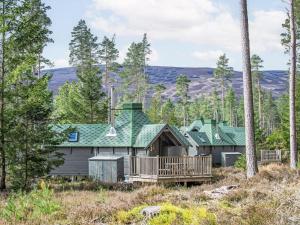 a house with a deck in the woods at Chalet Oak Bothy by Interhome in Coldstone