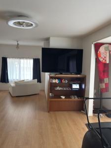a living room with a large flat screen tv at Bluebase 波音 in Goto +20 photos
