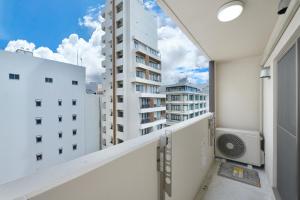 a balcony with a view of a building at Hotel HIRAKU RYUKYU -STYLE- in Naha