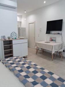a living room with a table and a tv at Ca' Dora in Otranto