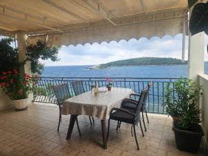 a table on a balcony with a view of the ocean at "Azzurra Apartments in Molunat