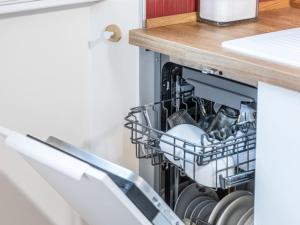 a dishwasher in a kitchen with dishes in it at Apartment Bacolla by Interhome in Cocconato +26 photos