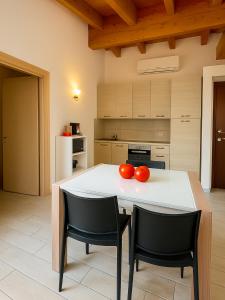 a kitchen with a table with two tomatoes on it at ValtellinaSuite in Villa di Tirano