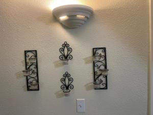 a wall with four pieces of art on it at Cozy Anchorage retreat in Anchorage