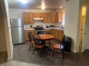 a kitchen with a table and chairs and a refrigerator at Cozy Anchorage retreat in Anchorage +12 photos