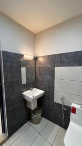 a bathroom with a sink and a toilet at Peacock residency in Edavanna