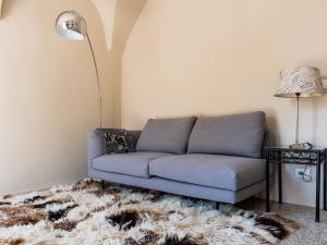 a living room with a couch and a rug at Apartment Nella Piazza by Interhome in Airole