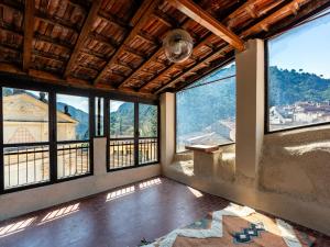a room with windows and a view of a mountain at Apartment Nella Piazza by Interhome in Airole