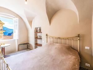 a bedroom with a bed and a window at Apartment Nella Piazza by Interhome in Airole