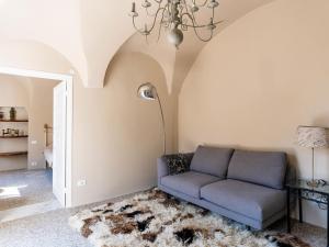 a living room with a couch and a chandelier at Apartment Nella Piazza by Interhome in Airole +26 photos